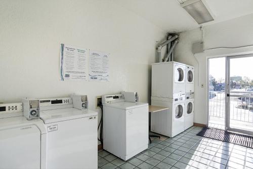 a laundry room with white appliances and a window at Motel 6- Denver, CO Downtown in Denver