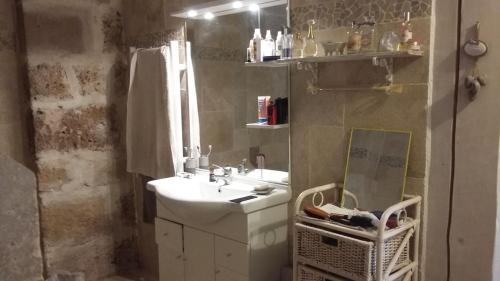 a bathroom with a sink and a mirror at loft appartement dans bastide in La Celle-sous-Gouzon