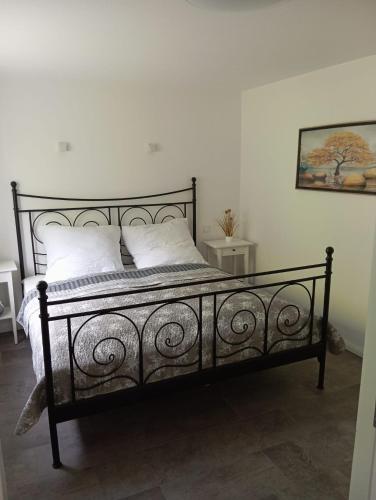 a black bed with white pillows in a bedroom at Villa am Bacho in Dörzbach