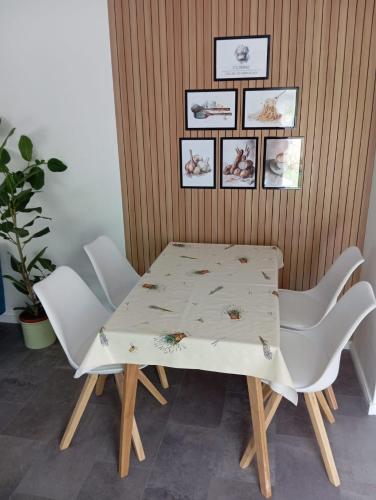 a table and chairs in a dining room at Villa am Bacho in Dörzbach