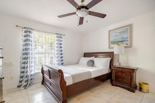 a bedroom with a bed and a ceiling fan at Tampa Stadium Vacation Rental in Tampa