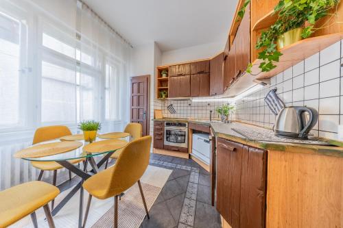 a kitchen with a table and chairs in a kitchen at The Heart of the City in Bratislava