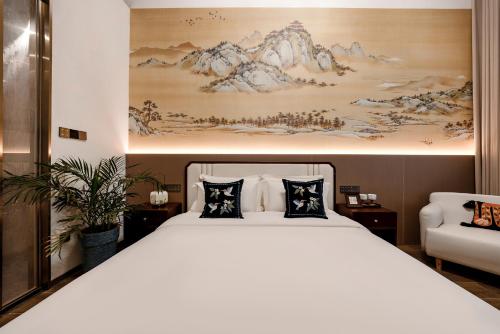 a bedroom with a large bed with two pillows at Lishè Hotel in Pingyao