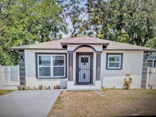 a house with a door in a yard at Tampa Stadium Vacation Rental in Tampa