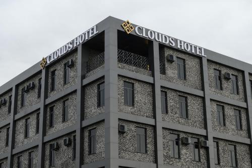 a building with the cloulds hotel on top at Clouds Hotel in Tashkent