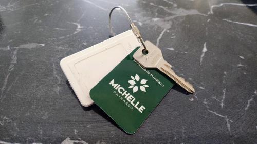 a tag with a flower on it on a table at MICHELLE PATRASSO - Quiet & comfortable apartment in Patras with free parking in Patra