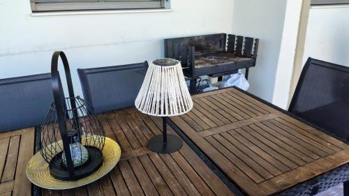 a lamp sitting on a wooden table on a deck at MICHELLE PATRASSO - Quiet & comfortable apartment in Patras with free parking in Patra