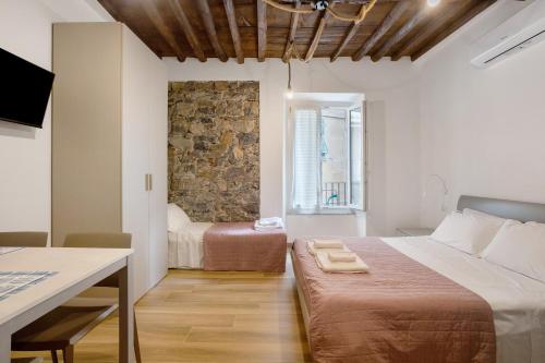 a bedroom with a bed and a table and a window at Matt House in La Spezia