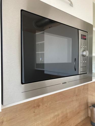 a microwave oven sitting on top of a counter at Star Apartments Brno #5D515 by Starbnb EU in Modřice