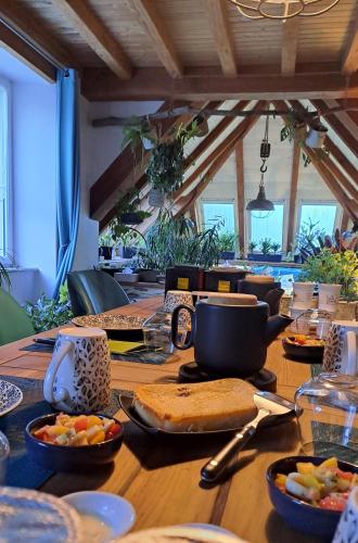 a wooden table with plates of food on it at Moulin de Kervegan in Plouzélambre