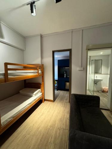 a living room with bunk beds and a couch at Greatwood Residence at Devonshire in Singapore