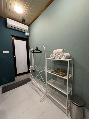a bathroom with a towel rack in a room at Woodstock Camp Chalet in Bentong