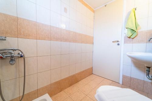 a bathroom with a shower and a sink at Beachfront Cozy Apartments in Amoudara Herakliou