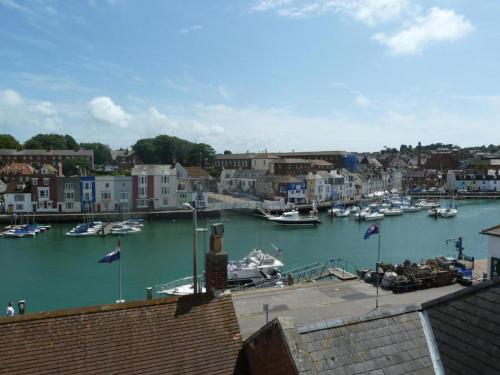 a view of a harbor with boats in the water at Bayliss Hall in Weymouth