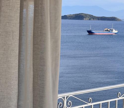 a boat in the water with a balcony at amfiliki in Skiathos Town