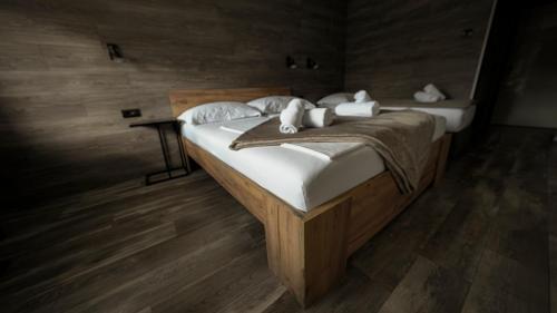 a bedroom with a bed with white sheets and pillows at Hotel Matija Gubec in Stubicke Toplice
