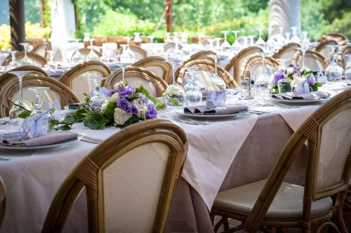 a row of tables with plates and flowers on them at Da Gelsomina in Anacapri