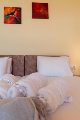 a bed with wrapped towels on top of it at Mesopotam Agrotourism Resort in Sarandë