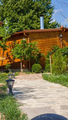 a building with a stone driveway in front of it at Mesopotam Agrotourism Resort in Sarandë