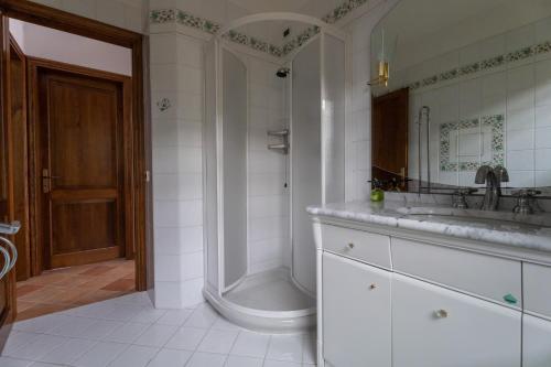 a bathroom with a shower and a sink and a tub at Villa Marisa in Stazzema