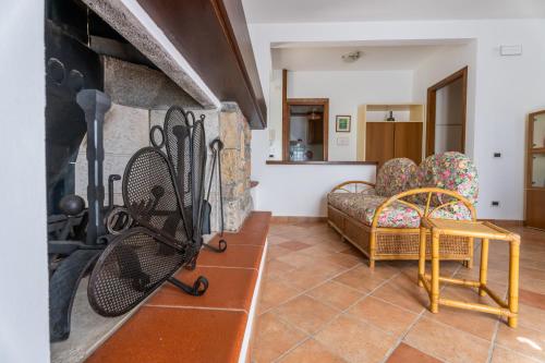 a living room with a fireplace and a couch at Villa Marisa in Stazzema