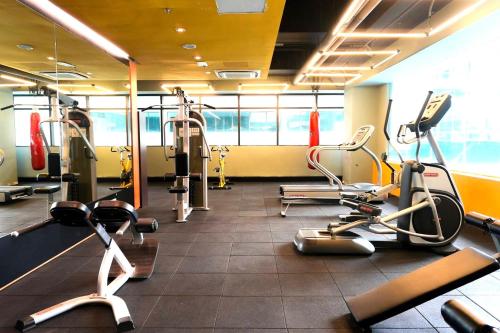 a gym with treadmills and cardio equipment in a room at Riverson SOHO Kota Kinabalu in Kota Kinabalu