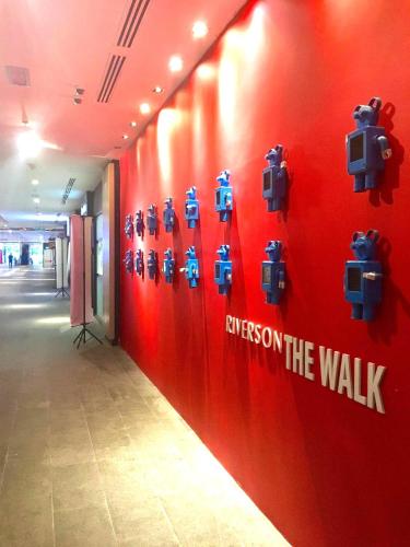 a red wall with robots on the wall at Riverson SOHO Kota Kinabalu in Kota Kinabalu