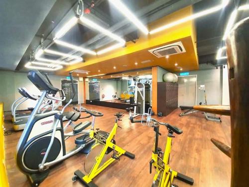 a gym with several exercise bikes in a room at Riverson SOHO Kota Kinabalu in Kota Kinabalu