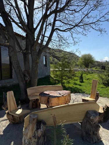 a picnic table and chairs sitting next to a tree at MM HOUSE Stepanavan in Stepʼanavan