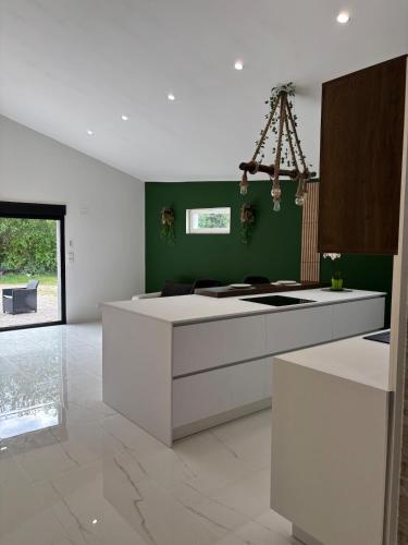 - une cuisine avec un îlot blanc dans une chambre dans l'établissement La Champoternoise, à Belval-sous-Châtillon