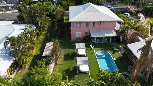 an aerial view of a pink house with a swimming pool at Villa Rosa Karibella in Saint-François