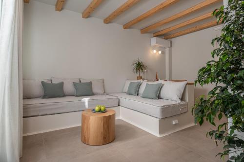 a living room with a couch and a table at Castello Amorgos Suites in Katapola