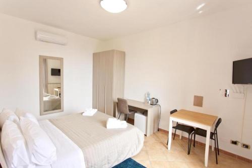 A bed or beds in a room at La Villa Carmelina