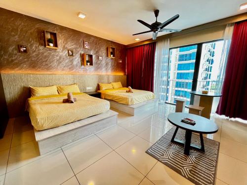 a bedroom with two beds and a table in it at Serene Trefoil Home - Walk to Setia City Mall & Setia City Convention Centre in Shah Alam