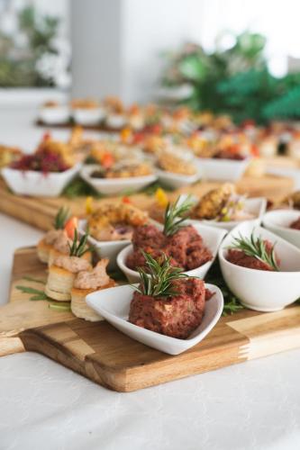 a buffet of food on a table with bowls of food at Hotel Matija Gubec in Stubicke Toplice