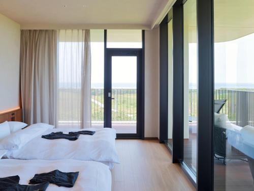Una cama o camas en una habitación de seven x seven ISHIGAKI