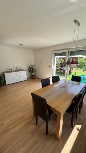 a dining room table and chairs in a room at Villa FRIDA in Rogaška Slatina