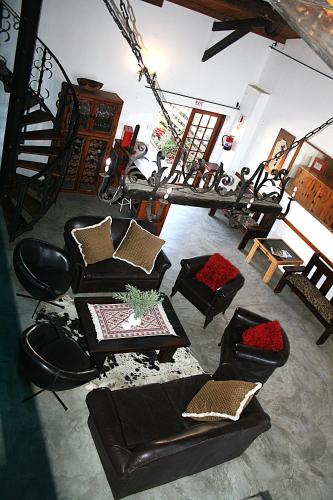 a living room with couches and a table at The Residence at Villa Wiese in Swakopmund