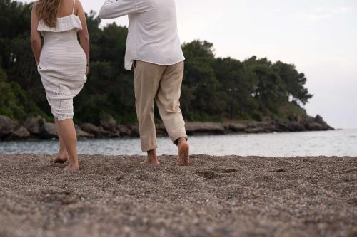 a man and a woman standing on a beach at Oz Hotels Sui in Alanya