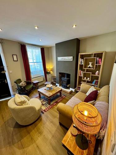 a living room with a couch and a table at Quaint Bury St Edmunds Cottage in Bury Saint Edmunds
