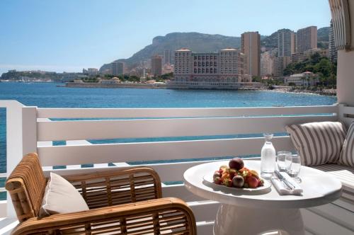 a table with a plate of fruit on a balcony at Monte-Carlo Beach in Roquebrune-Cap-Martin