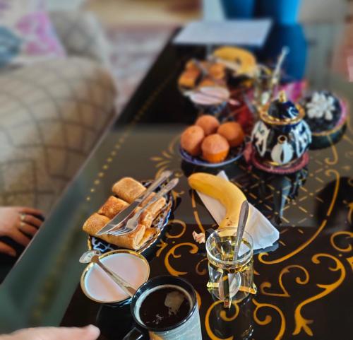 a table with a tray of breakfast foods on it at "Sofia" Guest House in Samarkand
