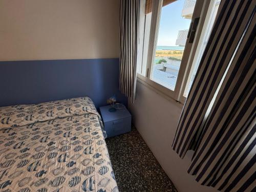 Ένα ή περισσότερα κρεβάτια σε δωμάτιο στο App4rent Villa Zanetti - Appartamenti con spiaggia privata frontemare