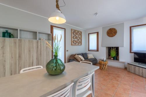 a kitchen and living room with a vase on a table at Isola di Albarella in Isola Albarella