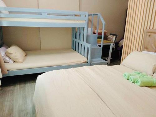 a bedroom with two bunk beds and a bed at Spacious Combine Family Unit Condo at Mesaverte Residences downtown near SM Gaisano Robinson and Centrio in Cagayan de Oro
