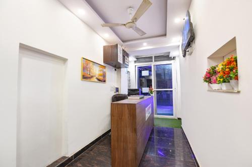 a corridor of a room with flowers on the wall at FabHotel NP International - Nehru Place Market in Jāmb