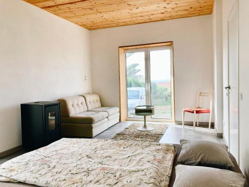 a living room with a bed and a couch at early afternoon Boutique Stay in Ferrel