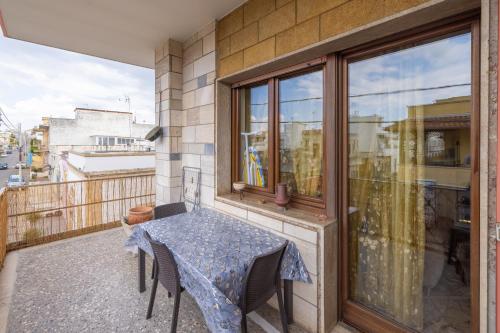 a balcony with a table and chairs and a window at Casa Graziella the top holiday home in Ugento