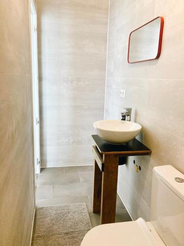 a bathroom with a sink and a toilet at early afternoon Boutique Stay in Ferrel