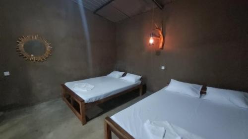 a bedroom with two beds and a mirror in it at Royal Mountain Edge ,Knuckles in Rangala